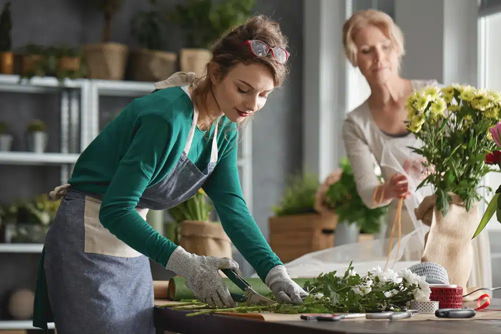 Female florists creating floral arrangements in a creative workspace