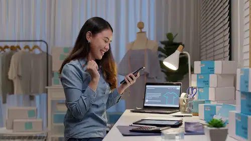 Excited eCommerce business owner celebrating online sales success