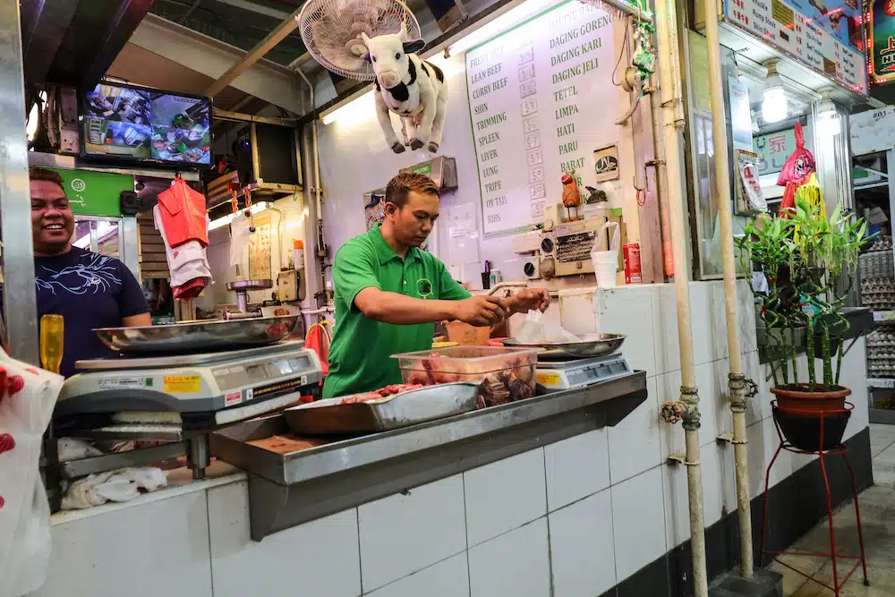 Butcher preparing fresh meat in a traditional market stall